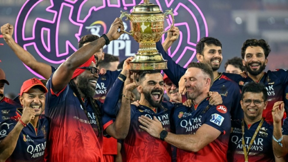 Royal Challengers Bengaluru's Virat Kohli (centre) and teammates celebrate the team's IPL final victory in June this year
