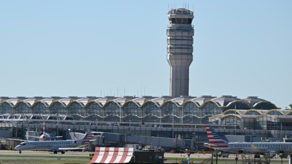 Travelers wait in line at a security checkpoint at O'Hare International Airport in Chicago, Illinois on November 7 2025
