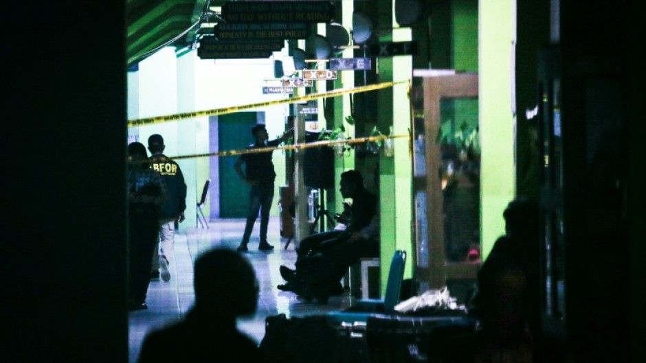 Authorities investigate the aftermath of blasts at a high school in Jakarta on November 7, 2025
