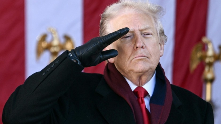 US President Donald Trump salutes at the conclusion of a Veterans Day ceremony at Arlington National Cemetery in Arlington, Virginia on November 11, 2025.