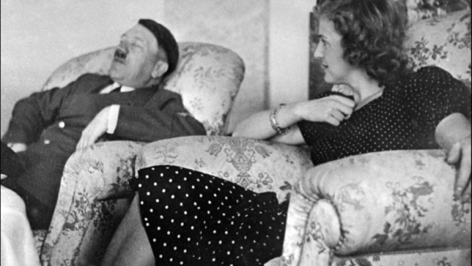 This undated and unlocated picture shows Hitler relaxing with his mistress Eva Braun