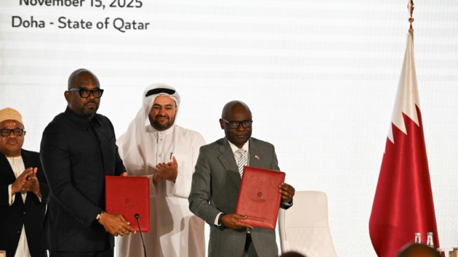 Officials from the rival DR Congo government and the Rwanda-backed M23 movement stand with a Qatari negotiator at the signing of a new roadmap seeking to establish a permanent peace in devastated eastern DRC