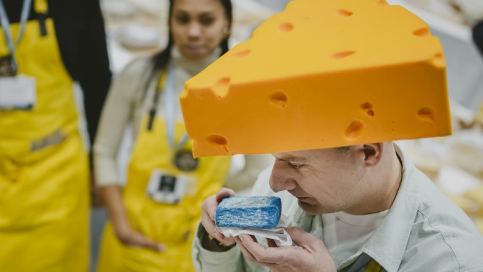 Kuba Maziarczyk sniffs a piece of cheese