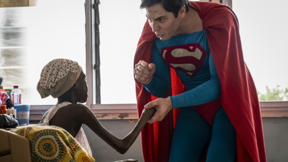 Leonardo Muylaert, known as the Brazilian Superman, greets a patient