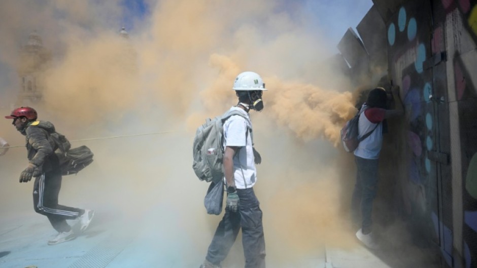Police protecting the compound used tear gas grenades and fire extinguishers to contain the protesters