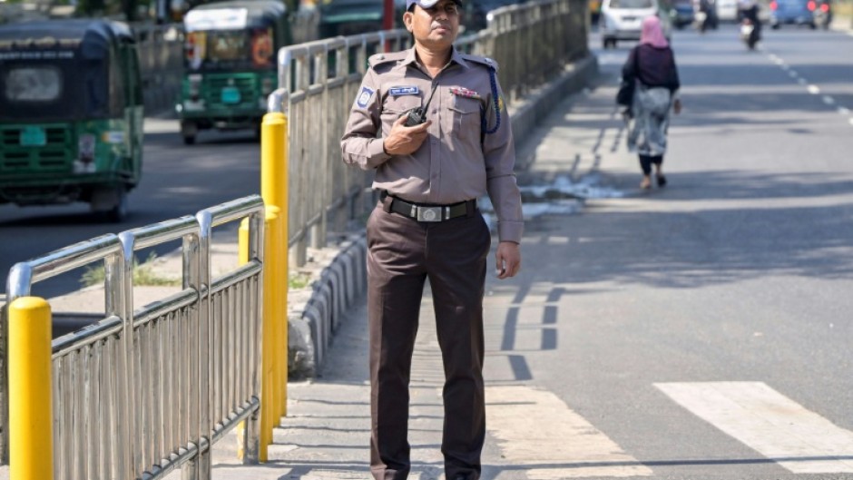 A Bangladesh police officer wears the new grey and brown uniform in Dhaka, but critics doubt whether the change in colours will mend the force's shattered reputation