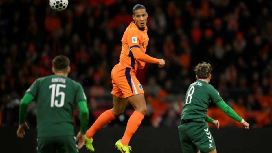 Heading to the World Cup: Virgil van Dijk of the Netherlands out jumps two Lithuanians