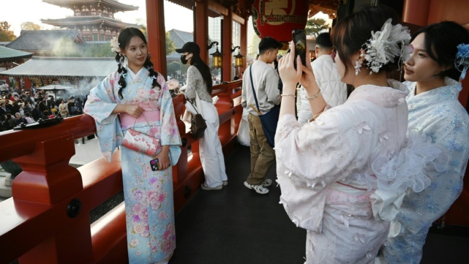 Chinese tourists wear kimonos as they visit the Sensoji Temple in Tokyo