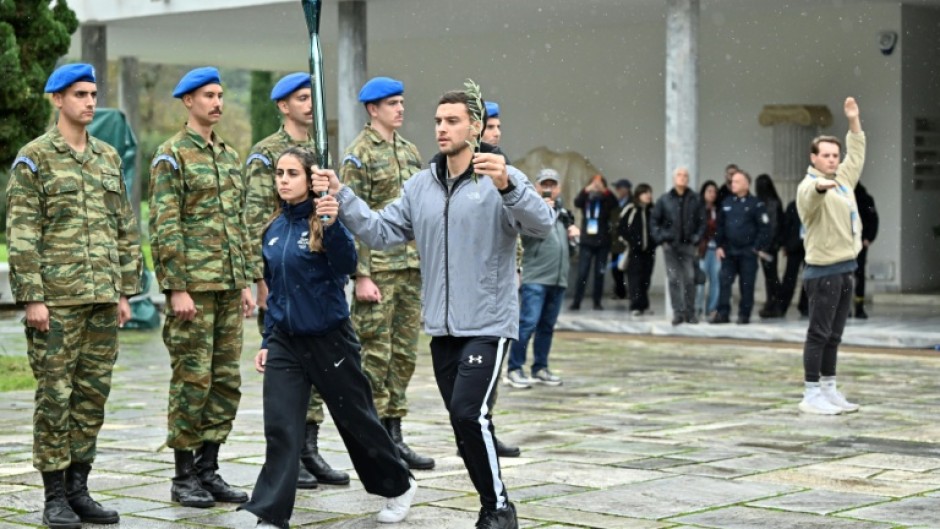Performers take part in a rehearsal of the lighting of the Olympic flame for the Milan-Cortina 2026 Winter Games