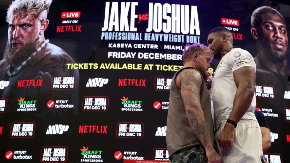 Jake Paul (left) and Anthony Joshua (right) face off at a press conference ahead of their Netflix-backed heavyweight fight next month