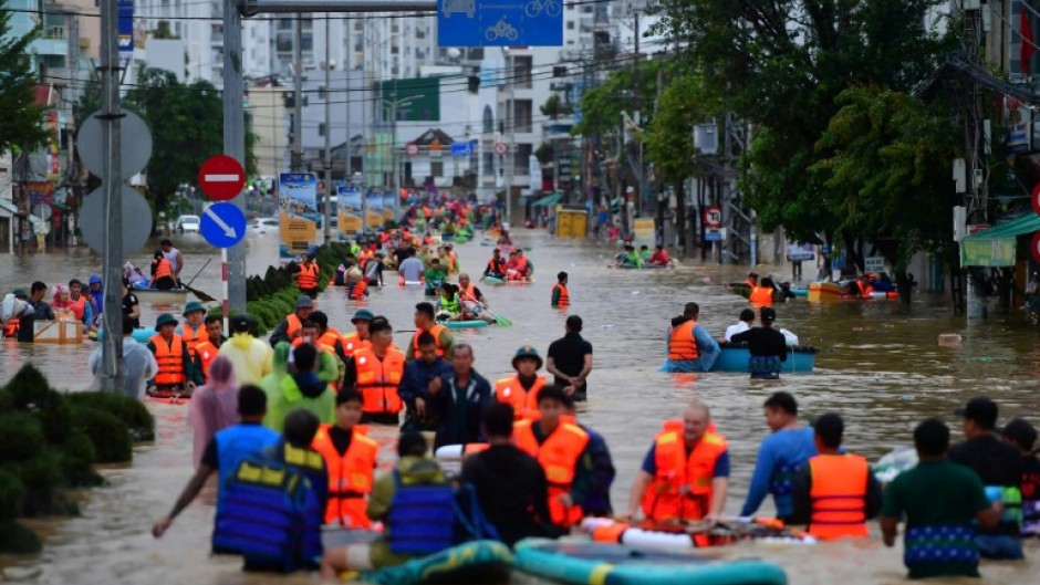People wade through floodwaters in Vietnam's coastal Nha Trang city