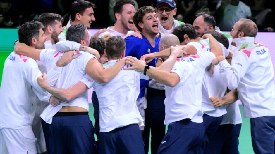 Flavio Cobolli (C) is mobbed by his team-mates after sealing another Davis Cup triumph for Italy