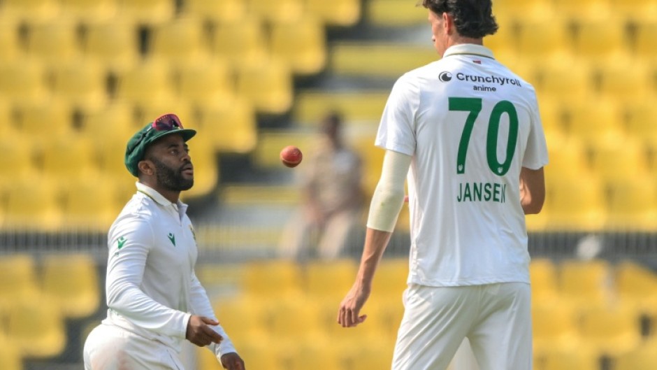 South Africa's captain Temba Bavuma (left) speaks with pace bowler Marco Jansen