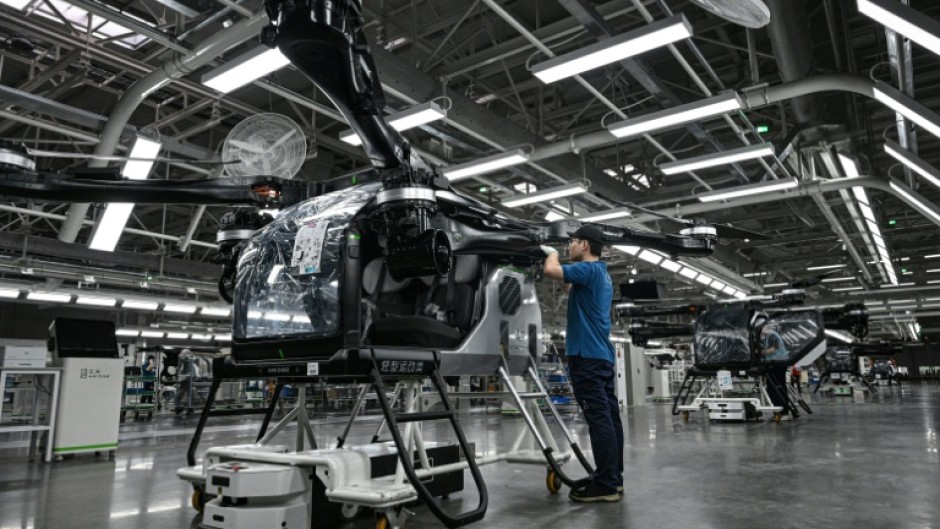 Employees work on the assembly line for the electric flying car at a factory of Xpeng's subsidiary Aridge