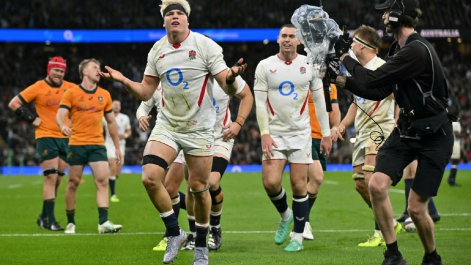 England's Henry Pollock (C) celebrates after scoring a try against Australia at Twickenham