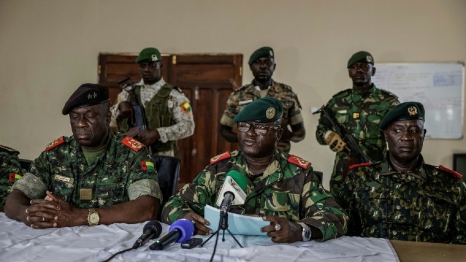 Brigadier General Denis N'Canha (C), head of the military office of the presidency, gave a press conference announcing the takeover