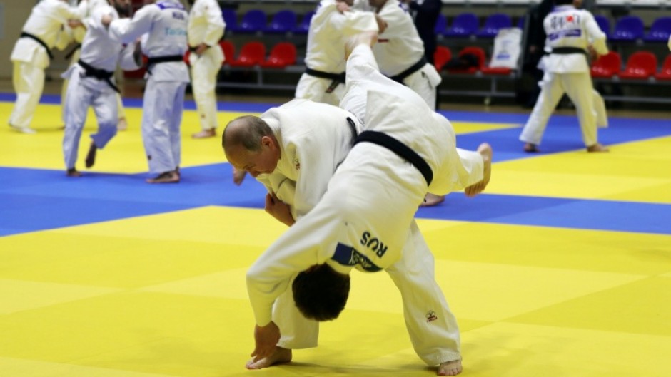 Russian President Vladimir Putin (L) adores judo so will be delighted Russia's judokas can once again compete under the national flag after a three-year hiatus