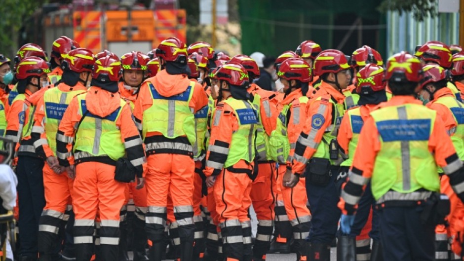 Fire department rescue teams gather after a blaze swept through several apartment blocks at the Wang Fuk Court residential estate in Hong Kong's Tai Po district