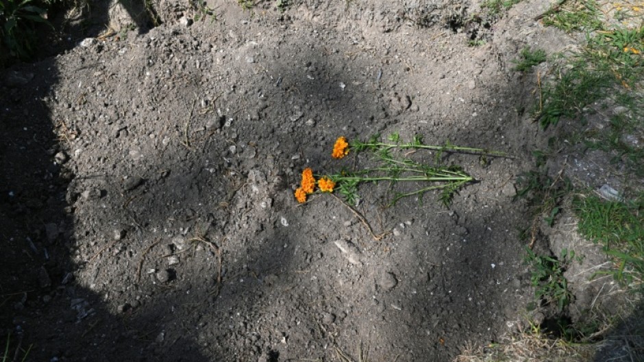 Flowers have been place on a mass grave at a cemetery in Mexico City, where thousands of unidentified bodies have been buried
