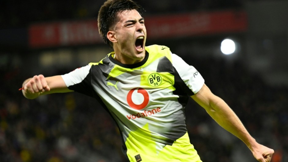 Borussia Dortmund defender Aaron Anselmino rose high to head a Daniel Svensson cross in off the post