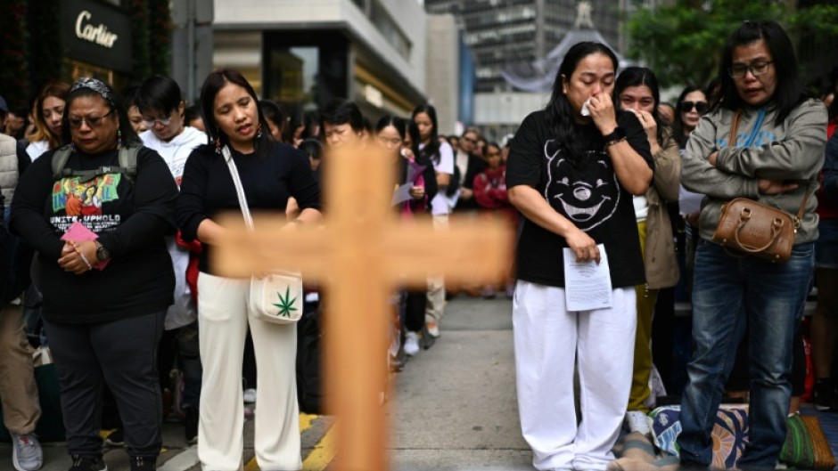Filipinas in Hong Kong take part in a prayer service for victims of the Tai Po fire. At least 10 of the 146 killed were migrant workers