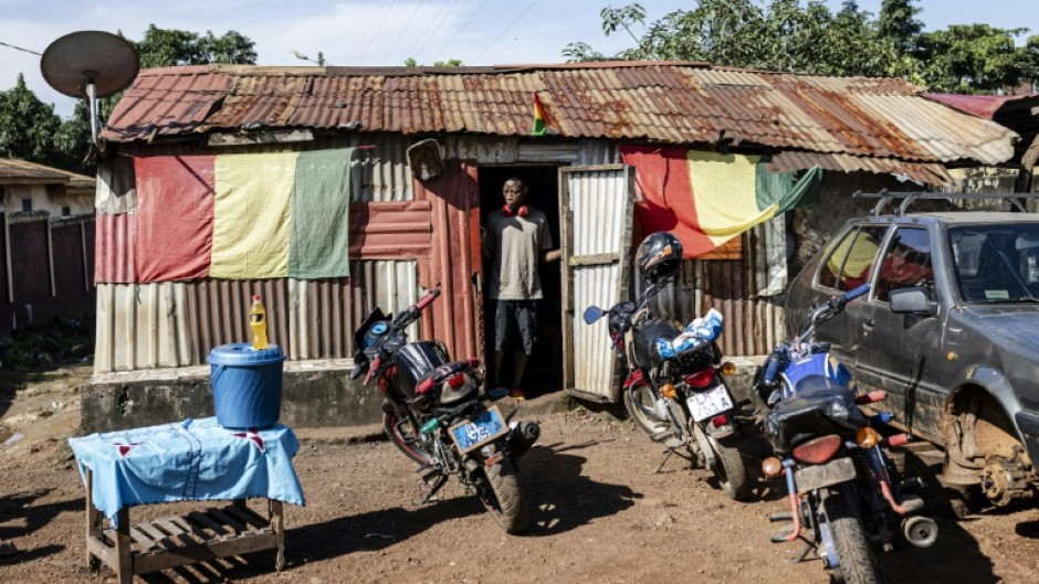 A man stands at the door of a makeshift cafe in Conakry's Yattaya T6 suburb, where young people who spoke to AFP had gathered