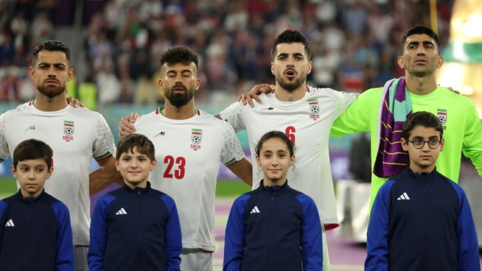 Iranian players sing the national anthem before their World Cup match against the USA at the 2022 tournament in Qatar