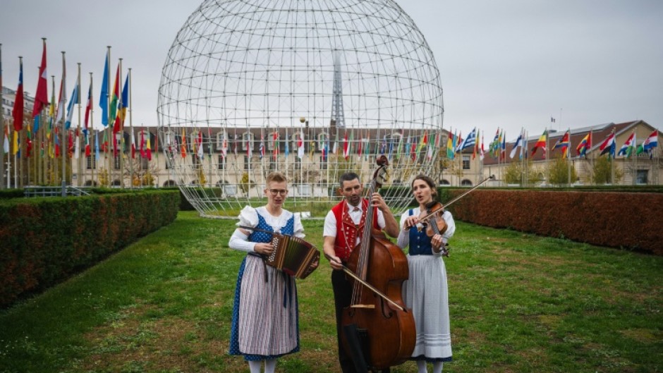 Katja Burgler (L), Maya Stieger (R) and Peter Looser perform in the garden of the UNESCO headquarters in Paris