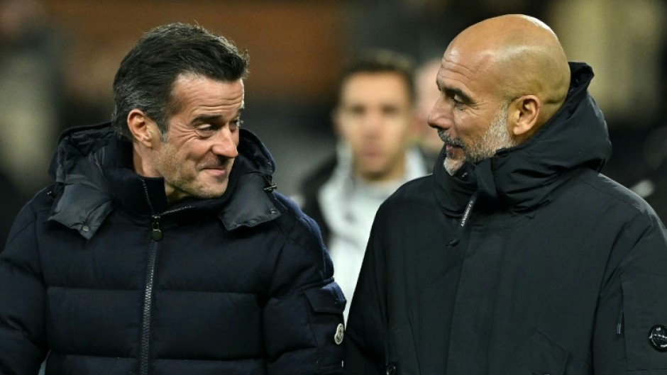 Fulham manager Marco Silva (left) speaks with Manchester City boss Pep Guardiola at Craven Cottage