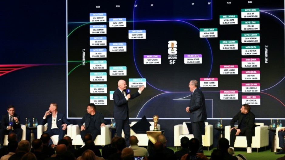 FIFA president Gianni Infantino (center-L) speaks on stage on Saturday as the match schedule for the 2026 World Cup is revealed
