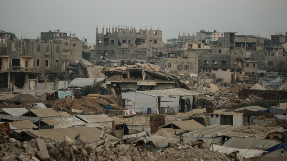 Displaced Palestinians set up their tents surrounded by rubble from buildings destroyed by the Israeli military in central Gaza