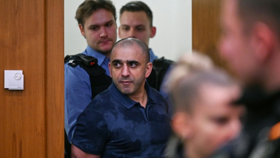 Co-defendant Arman S. is led into the courtroom for the start of the trial