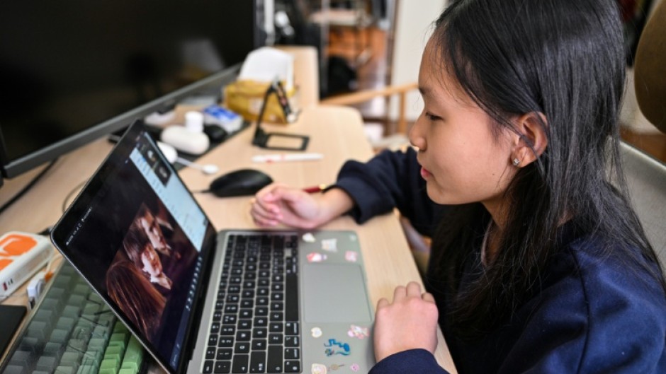 Estella, 14, a homeschooled student, does a Spanish class from her bedroom in Shanghai