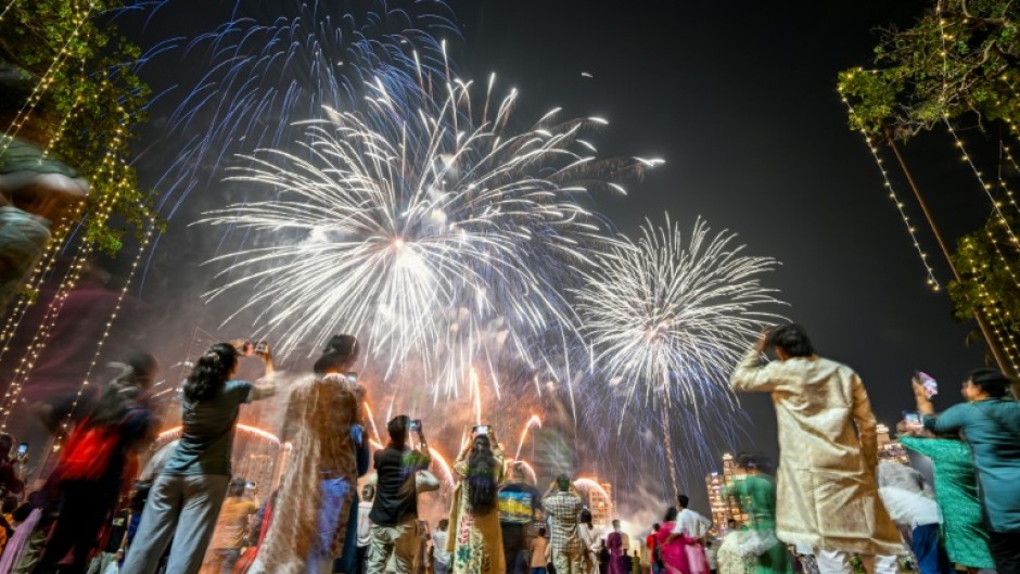 People watch fireworks light up the sky as part of Diwali celebrations in Mumbai in October