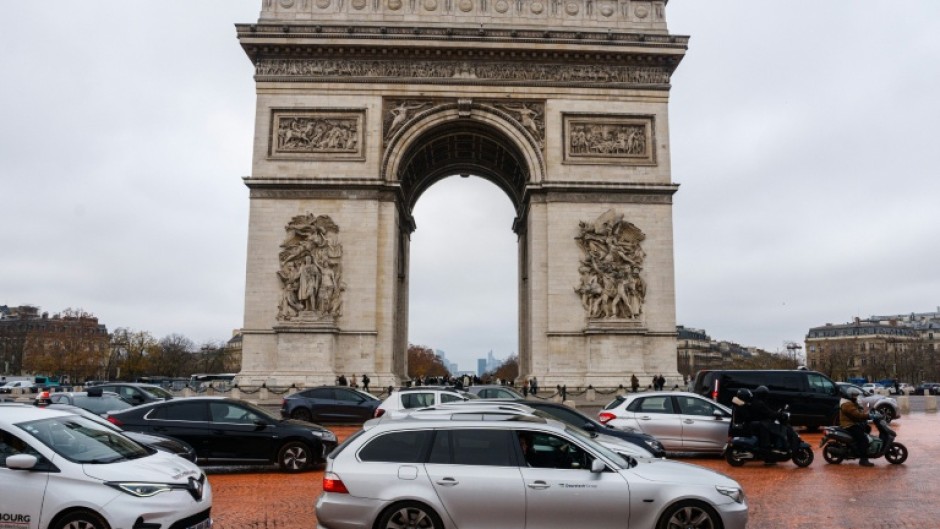 Greenpeace dumped orange paint in front of the Arc de Triomphe on the 10th anniversary of the Paris Agreement