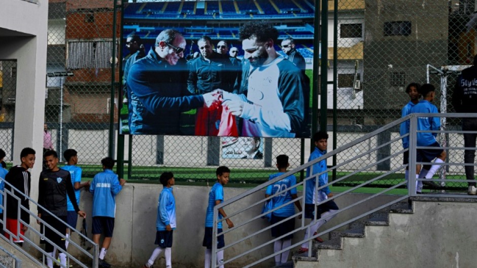 Young footballers head for the pitch at the Mohamed Salah sports complex in Nagrig