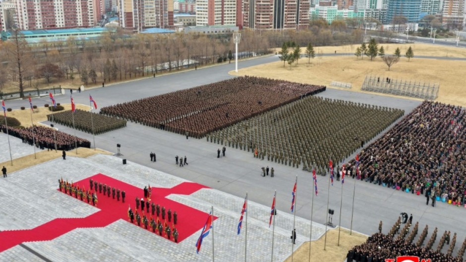A picture released by North Korea's official Korean Central News Agency (KCNA) on December 13 showing North Korean leader Kim Jong Un (at podium) attending a welcoming ceremony for the Korean People's Army's 528th Regiment of Engineers, which returned from an overseas deployment in Russia's Kursk region during Moscow's war with Ukraine