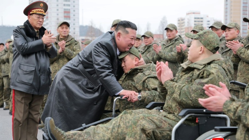 A picture released from North Korea's official Korean Central News Agency (KCNA) showing North Korean leader Kim Jong Un welcoming soldiers