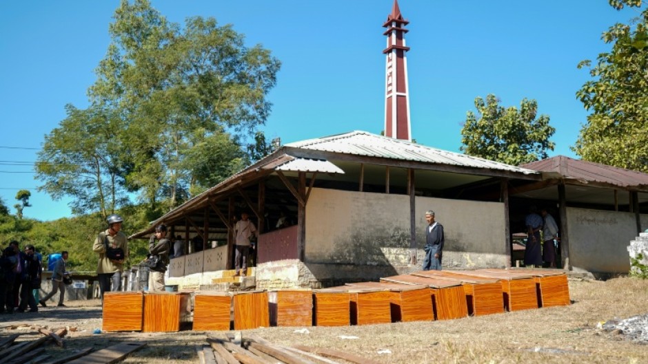 Coffins are prepared at a cemetery for victims of a Myanmar military air strike at a hospital