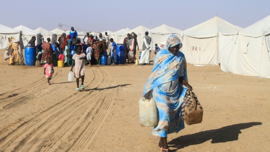 Sudanese who fled massacres and sexual violence in El-Fasher in Darfur carries jerrycans have sought refuge in camps in the north of the country