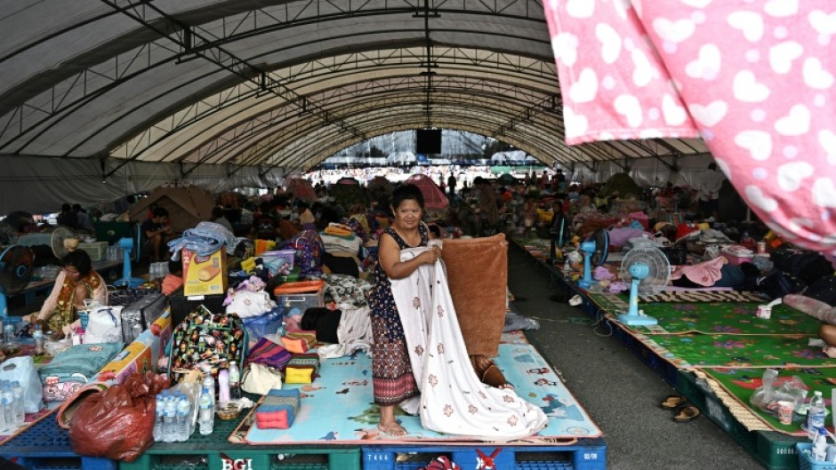 Displaced residents rest at an evacuation centre at Chang International Circuit in the Thai border province of Buriram