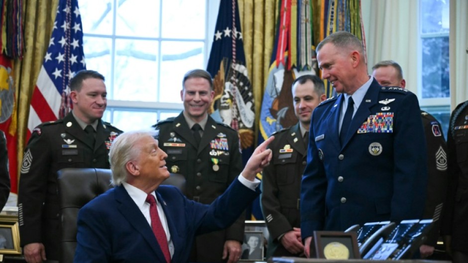US President Donald Trump speaks with military officers at the White House