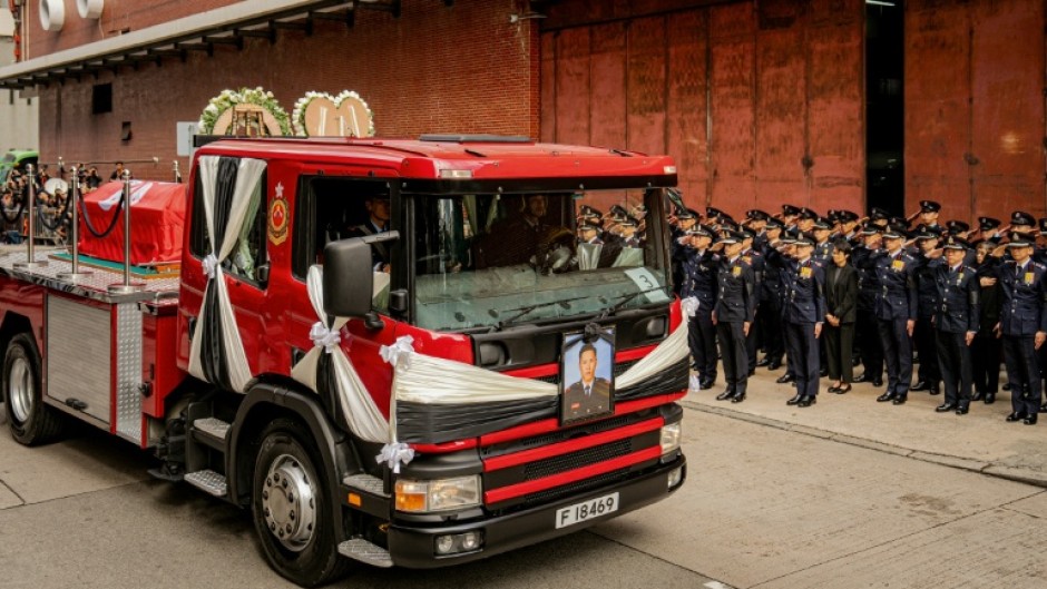 Ho's coffin passed by on the back of a truck bedecked in ribbons and floral tributes