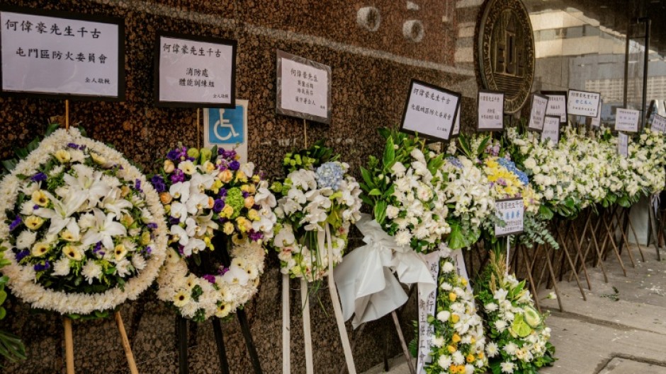 Floral tributes placed in mourning at the funeral for firefighter Ho Wai-ho, who died in the deadly fire at the Wang Fuk Court