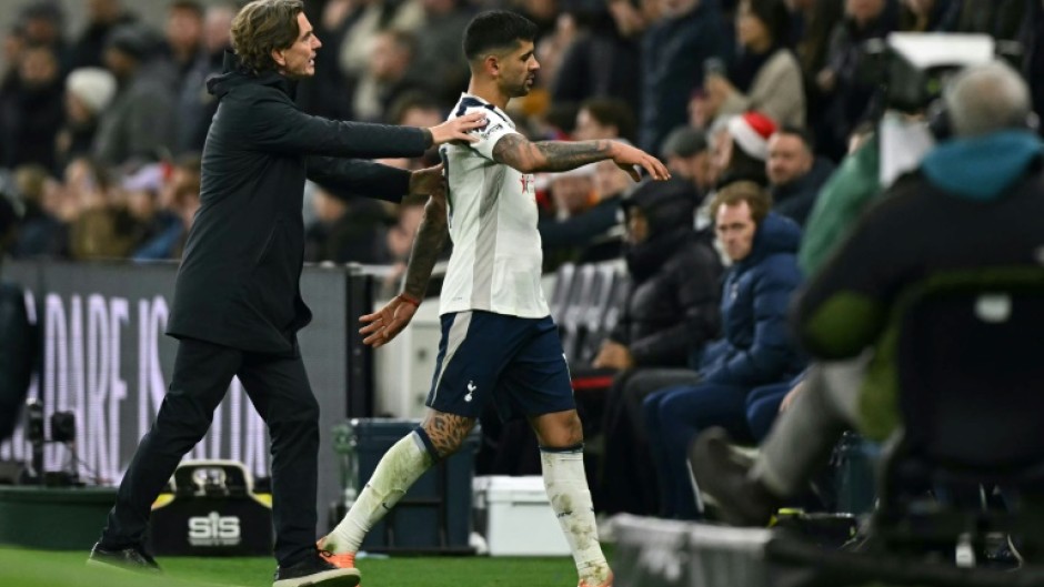 Tottenham captain Cristian Romero is ushered off the pitch by head coach Thomas Frank after being sent off in a 2-1 Premier League defeat by Liverpool