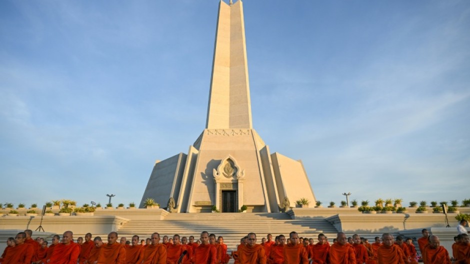 Cambodian Buddhist monks participate in a prayer for peace at the Win-Win monument
