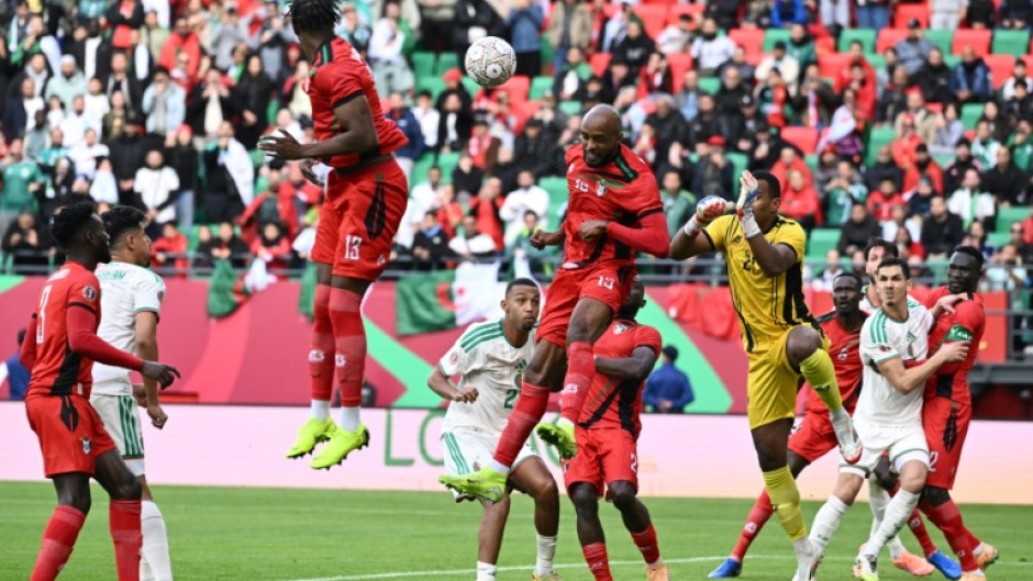 Sudan players (in red) in action against Algeria at the Africa Cup of Nations in Morocco