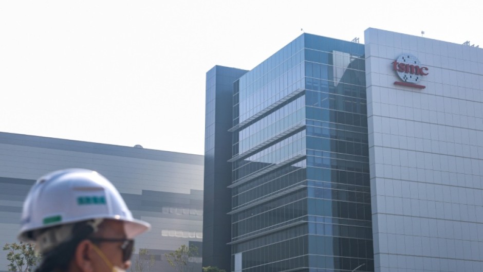 A worker walks past the 2-nanometer fabrication plant of TSMC at Nanzih Technology Industrial Park in Kaohsiung on December 23, 2025