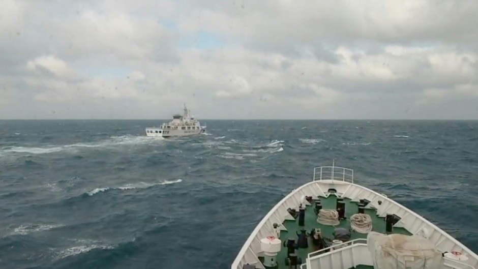 A Taiwan coastguard vessel (R) responds to a China Coast Guard ship (L) during Chinese military drills around Taiwan