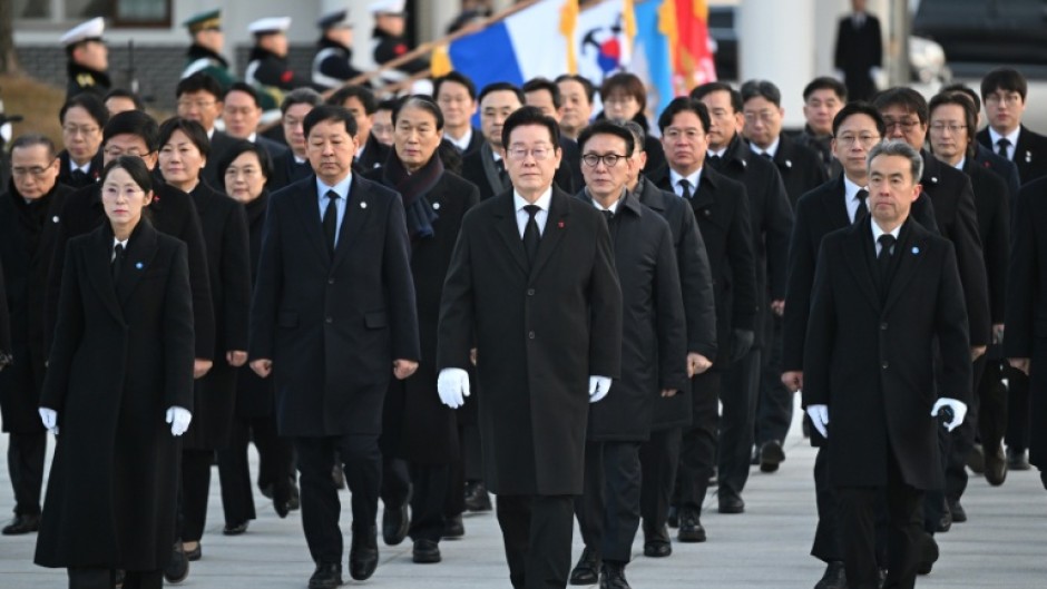 South Korean President Lee Jae Myung (centre) walks with his cabinet members as he visits the National Cemetery in Seoul on January 1. Soaring global demand for semiconductors fuelled by a boom in artificial intelligence sent South Korea's exports to their highest-ever level in 2025